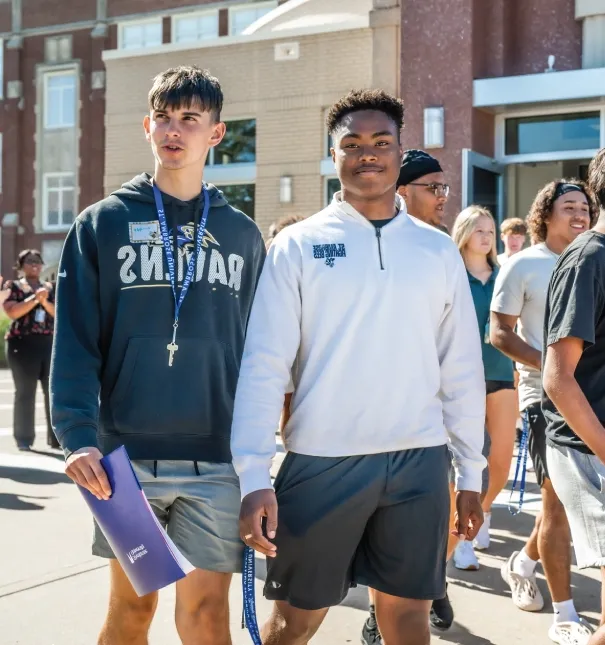 Two students exiting the chapel after an event.